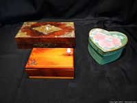 Five cedar boxes including one detailed with cameo, and at least two with brass corners along with a heart-shaped floral painted box