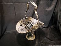 Side view showing the full shape, lattice pattern, and floral decorations on the basket and handle.