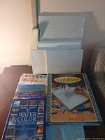 Overview showing watercolor books, LightTracer box, blank canvases, and watercolor palette tray.