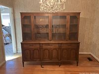 Front view of the full Canadian solid wood hutch and buffet set, showing four glass doors on the hutch and four cabinet doors with drawers below.