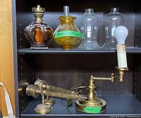 Shelf with oil lamp, lamp with adjustable arm, and multiple glass chimneys