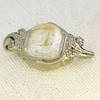 Close up of Helbros ladies watch with diamond accented case and decorative lugs