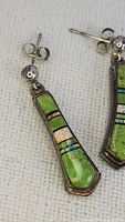 Pair of rectangular tapered drop earrings in sterling silver with green zoisite, opal, and ruby stone inlays, showing front view and details.