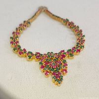 Photo showing the entire necklace laid flat with detailed view of the layered stone arrangement and large pendant.