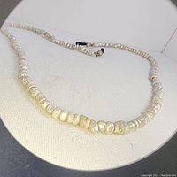 Photo showing close-up of the natural seed pearl beads with the attaching clasp.