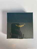 Front image of navy blue box with gold VUUJUV logo, fully sealed in plastic wrap.