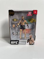 Front view of Conor McGregor UFC action figure in sealed box showing figure, accessories, and branding details.