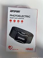 Front of the packaging showing the iGPSPORT photoelectric heart rate monitor HR60 and key features icons including app support, 5KHz, 20H battery, ANT+
