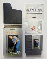 Front view of NES cartridge, original box, instruction manual, and black plastic protective sleeve for Jack Nicklaus' game