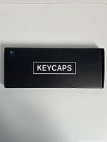 Closed black box labeled 'KEYCAPS'