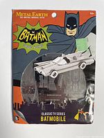 Front of sealed Metal Earth 3D metal model kit package featuring Batman classic TV series Batmobile model visible through blister pack.