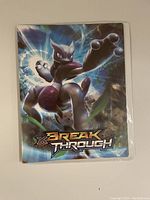 Binder cover showing the Pokémon Mewtwo image and Breakthrough logo