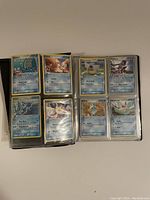 Photo showing Water type Pokémon cards inside binder sleeves such as Wooper, Shellder, Mantyke, and Mudkip