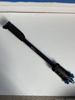 Full view of Ultimax UM-MP62-DLX camera tripod folded with legs and head mount visible.