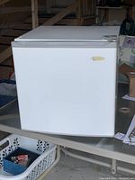 Closed view of white Coldspot mini fridge showing clean exterior and single door with handle on right side.