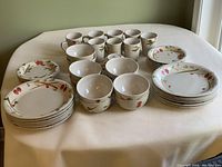 Full set including mugs, bowls, sandwich plates, and dinner plates with cherry design on white ceramic