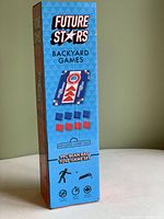 Box of Future Stars Backyard Games 9pc Bean Bag Toss Game Set, depiction of the game boards and bean bags in red and blue, includes carry bag, new in box