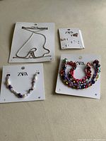 All items in the lot displayed on surface showing tags and brand Zara.