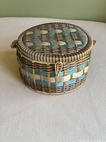 Closed round woven sewing basket showing detailed lid weaving and latch