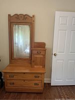 Front view of the entire dresser showing the mirror, drawers, and cupboard.