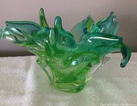 Front view of green and blue Chalet art glass bowl on white surface