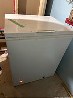 Frigidaire chest freezer exterior closed, showing white finish with some dirt and marks
