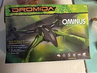 Box showing Dromida Ominus 2.4GHz Indoor/Outdoor Performance Drone with branding and features.