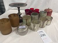 All candle holders and decorative jar arranged together showing variety and condition