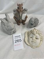 Full lot including squirrel salt and pepper shaker holder and three ceramic figurines on white background