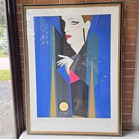 Front view of framed abstract print showing full piece, gold and black wood frame, glass reflection.