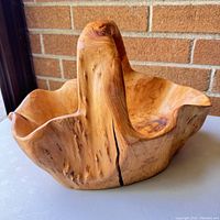 Side view showing the rich burl wood grain and a vertical crack in the handle.