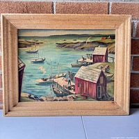 Full view of the vintage harbor landscape oil painting in a natural wood frame.