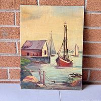 Full view of the vintage landscape oil painting showing boats, boathouse, dock, and water.