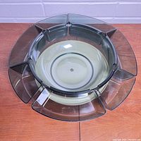 Top view of circular Lucite chip bowl set with 7 removable smaller bowls arranged evenly around a central bowl on the Lazy Susan base.