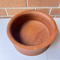 Top-down view showing the interior and rim of the teak bowl with visible wood grain and smooth texture.