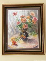 Framed floral watercolour painting with vibrant flowers in a decorative brown and gold frame.
