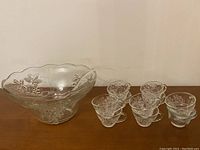 Wide view showing the punch bowl and ten matching cups arranged together