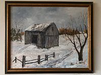 Frontal view of the oil painting showing the barn, tree, fence, and snow-covered landscape within a gold and brown frame.