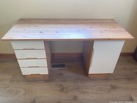 Front view of solid pine desk showing four drawers on the left and cupboard on the right