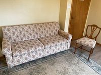 Floral double sofa bed angled view showing floral upholstery and shape.