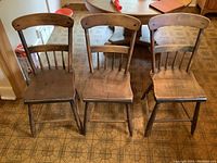 Three wooden chicken coop style chairs arranged side by side showing front and back views.