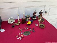 Wide angle showing all collectible items including bookends, figurines, pins, electric candle, and plaque.