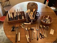 Wide shot showing all kitchen ware and baskets arranged on wooden table.