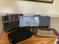 Lot overview photo showing five bags and one folded head kerchief.