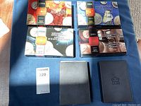 Six Royal Canadian Mint Prestige Proof Set presentation boxes including black folios for earlier years and themed boxes for 1998–2001