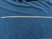 Full chain laid flat on blue background