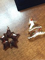 Photo showing both Christmas ornaments: gingerbread tree and star wreath.