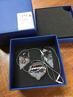 Set of three Swarovski crystal Christmas ornaments in original blue box with foam insert