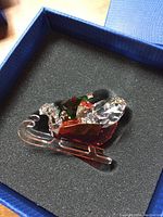 Photo of Swarovski Santa's sleigh figurine in black foam-lined blue box