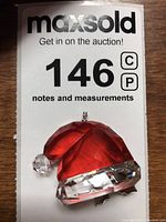 Front view of Swarovski crystal Santa hat with white pom-pom attached for hanging.